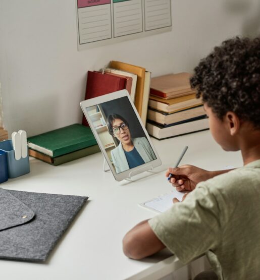 Students participating in an online lesson with engaging, multimedia resources provided by an international education company